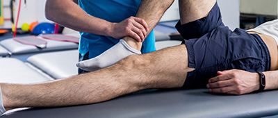 physical therapy session focusing on leg mobility with therapist assisting patient for recovery and rehabilitation 4 exercises