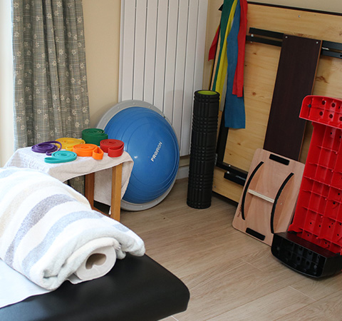 exercise equipment and tools for fitness therapy including a balance ball foam roller colorful weights and a towel suitable for workouts and rehabilitation 5 essential tools for health